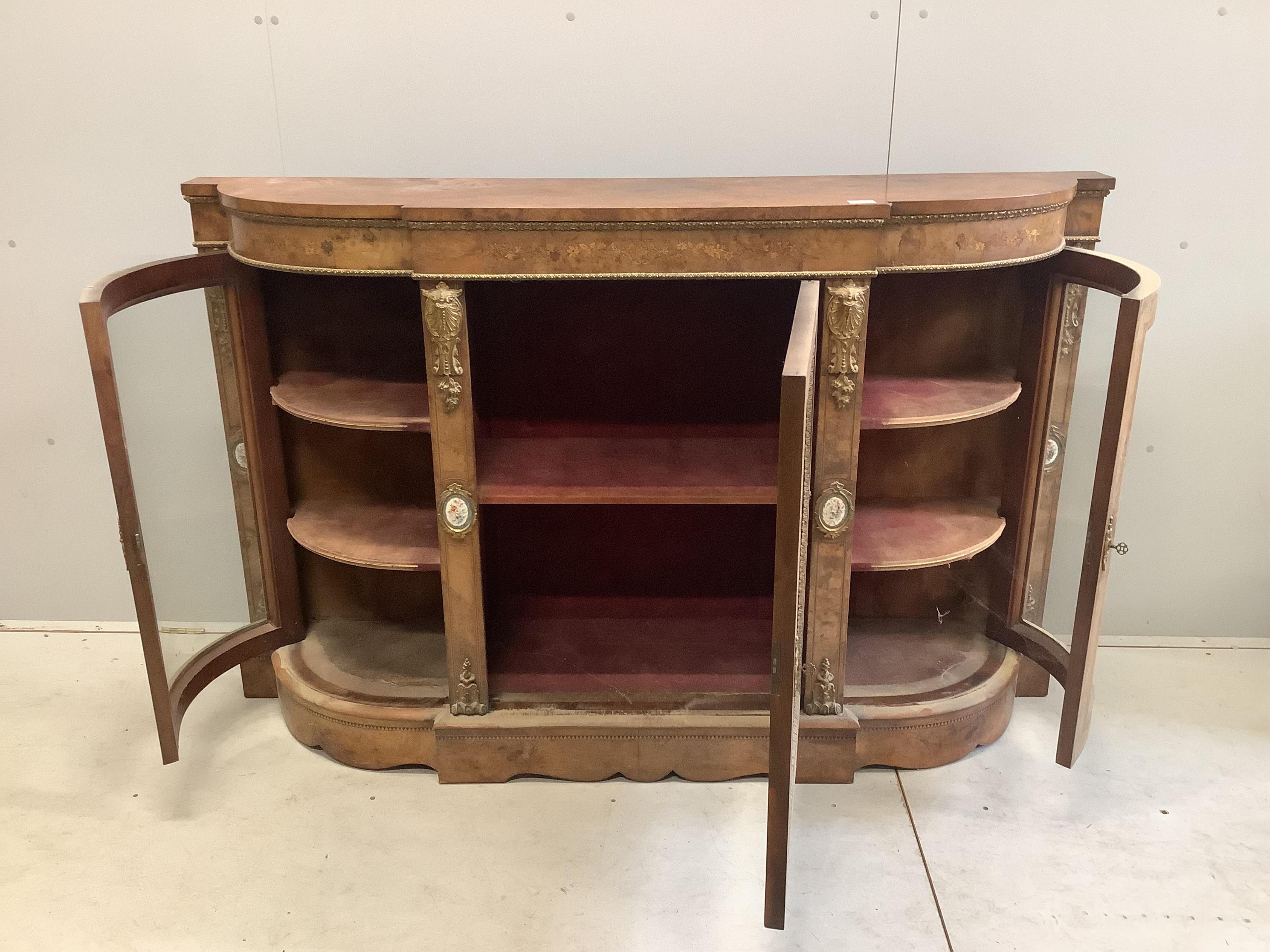 A Victorian marquetry inlaid, gilt metal mounted bowfront side cabinet